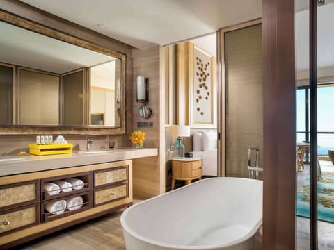 Combined shower/tub, designer toiletries, hair dryer, slippers