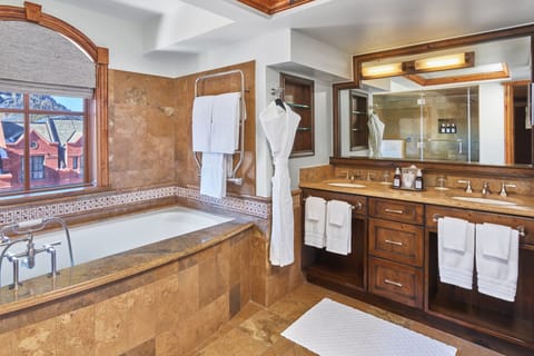 Separate tub and shower, designer toiletries, hair dryer, bathrobes