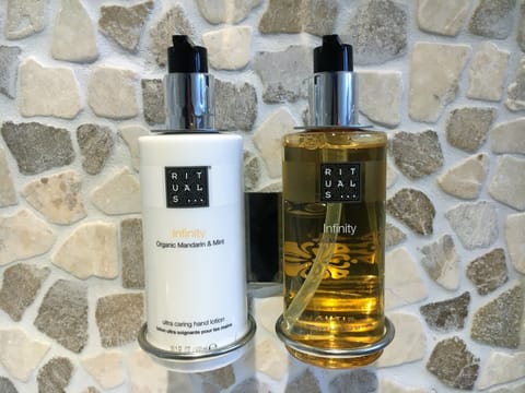 Shower, designer toiletries, hair dryer, towels