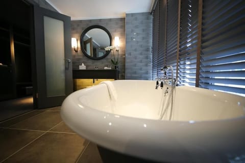 Signature Suite | Bathroom | Free toiletries, hair dryer, slippers, towels