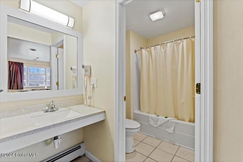 Room, 2 Double Beds | Bathroom | Combined shower/tub, free toiletries, hair dryer, towels