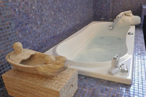 Deluxe Suite | Bathroom | Hair dryer, slippers, towels, soap