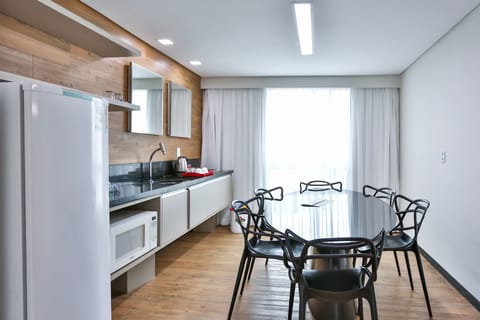 Family Suite | Private kitchen | Fridge, microwave, stovetop, dining tables