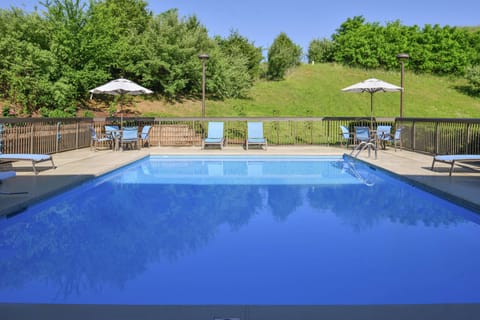 Seasonal outdoor pool, open 8:00 AM to 10:00 PM, pool umbrellas