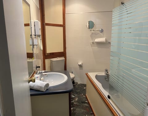 Grand Comfort Room, sea side | Bathroom | Hair dryer, towels