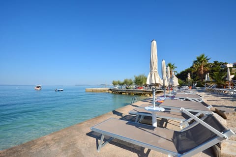 Private beach, white sand, sun loungers, beach umbrellas