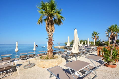 Private beach, white sand, sun loungers, beach umbrellas