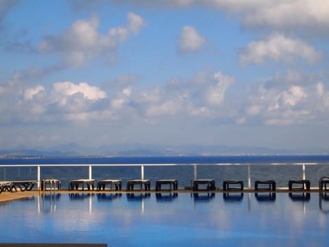 Seasonal outdoor pool, open 10:00 AM to 8:00 PM, pool umbrellas