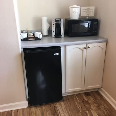 Fridge, microwave, coffee/tea maker, cookware/dishes/utensils