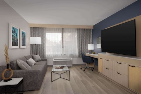 Suite, 1 King Bed | Living area | 42-inch flat-screen TV with satellite channels, TV, iPod dock