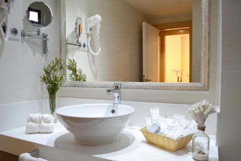 Deep soaking tub, rainfall showerhead, eco-friendly toiletries