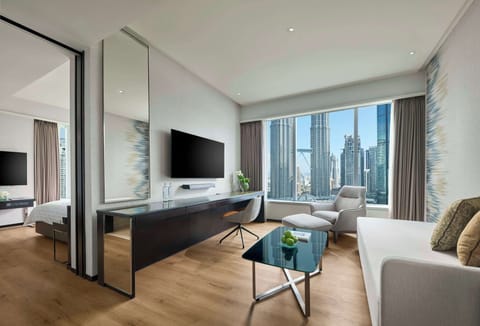 Suite, 1 King Bed (Twin Towers View) | Living room | 55-inch Smart TV with satellite channels