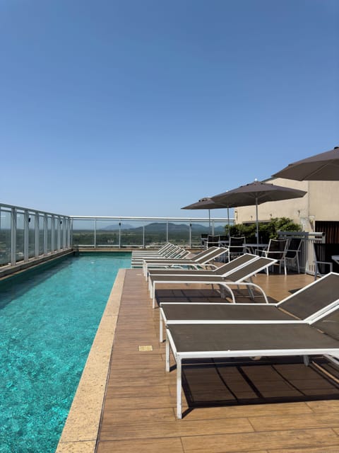 Outdoor pool, open 10:00 AM to 6:00 PM, pool umbrellas, sun loungers