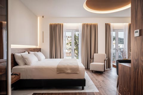 One Bedroom Junior Suite with Side Sea View | Desk, blackout drapes, iron/ironing board, free WiFi