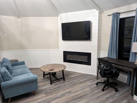 Honeymoon Studio Suite | Living area | 32-inch flat-screen TV with cable channels, TV, fireplace