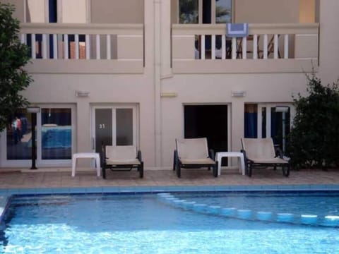 Outdoor pool, open 8 AM to 8 PM, pool umbrellas, sun loungers