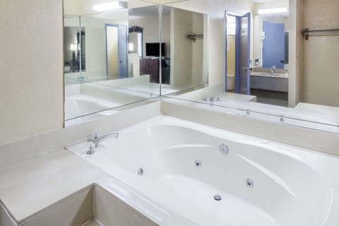 Room, 1 King Bed, Hot Tub | Bathroom | Combined shower/tub, deep soaking tub, designer toiletries, hair dryer