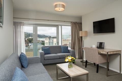 Apartment, 2 Bedrooms | Living area | Flat-screen TV, iPod dock, first-run movies