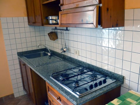 Full-size fridge, stovetop, coffee/tea maker, cookware/dishes/utensils