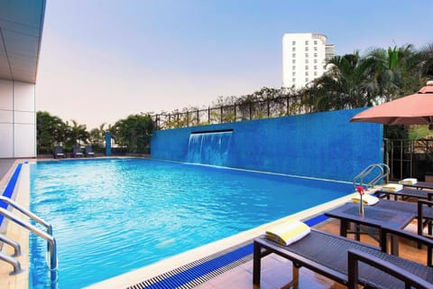 Outdoor pool, open 7:00 AM to 11 PM, pool umbrellas, sun loungers