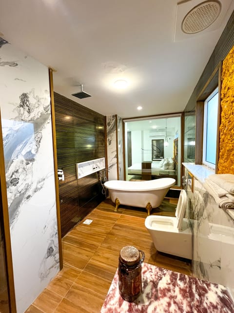 Signature Room | Bathroom | Separate tub and shower, jetted tub, rainfall showerhead