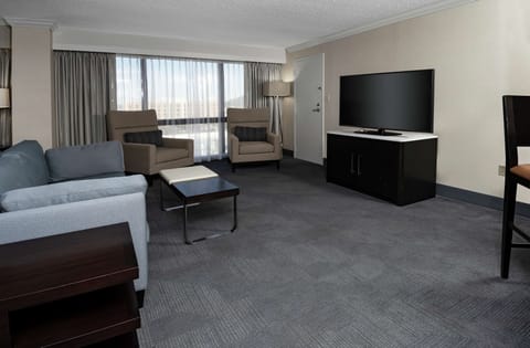 Suite, 1 King Bed | Living area | 42-inch LCD TV with cable channels, TV, MP3 dock