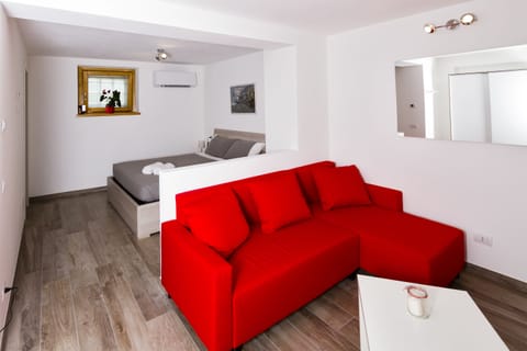 Basic Triple Room, 1 Queen Bed with Sofa bed, Private Bathroom | Living area | Flat-screen TV, pay movies