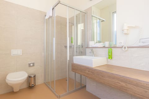 Family Studio, Multiple Beds, Kitchenette | Bathroom | Shower, free toiletries, hair dryer, towels