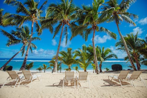 On the beach, white sand, sun loungers, beach towels