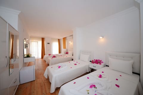 Signature Quadruple Room, Garden Area | Desk, free WiFi, bed sheets