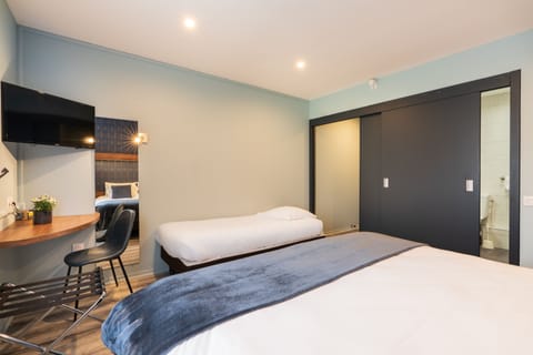 Superior Triple Room, Garden View | Desk, blackout drapes, iron/ironing board, free WiFi