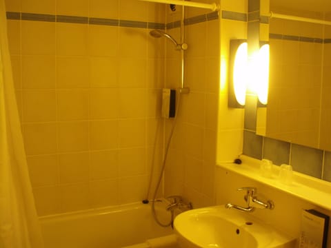 Bathtub, eco-friendly toiletries, hair dryer, towels