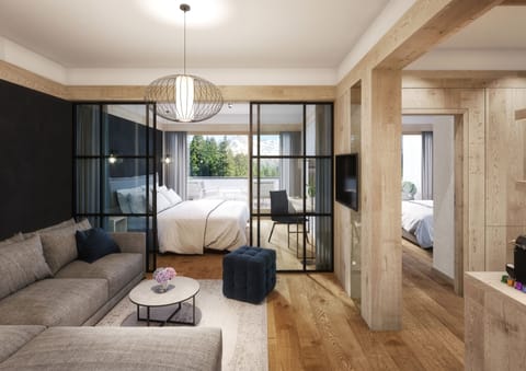 Suite (Bergwasser) | Living room | 49-inch flat-screen TV with cable channels, TV, tablet