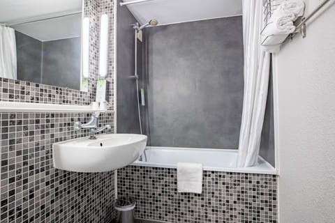 Bathtub, eco-friendly toiletries, towels