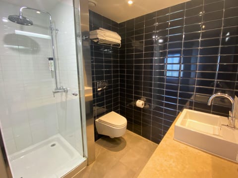 Shower, rainfall showerhead, hair dryer, towels