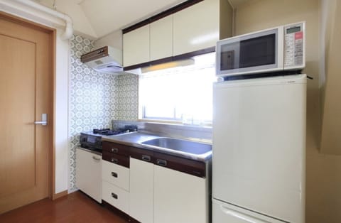 A large room for families use (W/Washing Machine) | Private kitchenette | Fridge