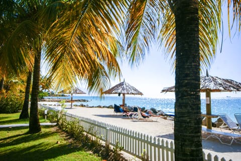 On the beach, white sand, sun loungers, beach umbrellas