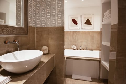 Suite | Bathroom | Designer toiletries, hair dryer, slippers, towels