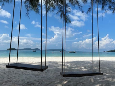 On the beach, white sand, sun loungers, beach umbrellas