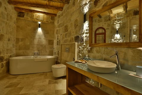 Exclusive Cave Suite | Bathroom | Designer toiletries, hair dryer, slippers, towels