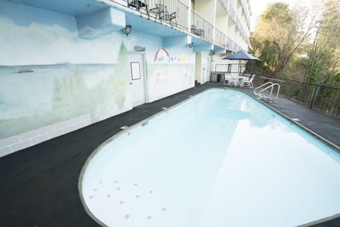 Seasonal outdoor pool, open 9:00 AM to 10:00 PM, pool umbrellas