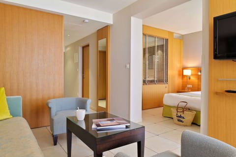 Suite, Sea View | Minibar, in-room safe, desk, blackout drapes