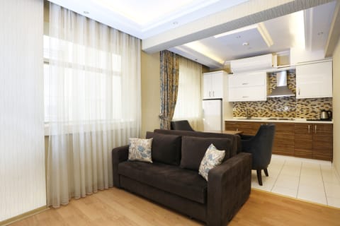 Family Studio Suite, 1 King Bed with Sofa bed, Kitchen | Living area | LED TV