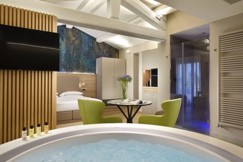 Deluxe Studio Suite | Living area | LCD TV, first-run movies