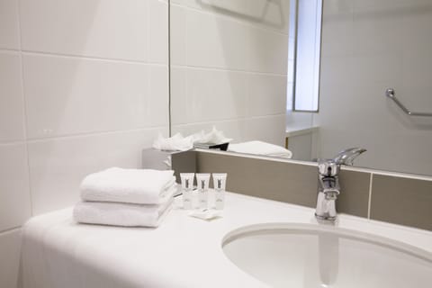 Shower, designer toiletries, hair dryer, towels