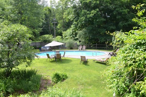 Seasonal outdoor pool, open 10:00 AM to 7:00 PM, pool umbrellas