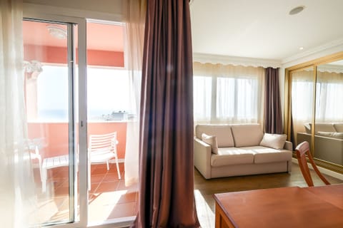 Junior Suite, Partial Ocean View | Premium bedding, minibar, in-room safe, desk