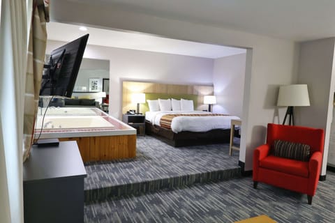 Suite, 1 King Bed, Non Smoking, Jetted Tub | Desk, laptop workspace, blackout drapes, iron/ironing board