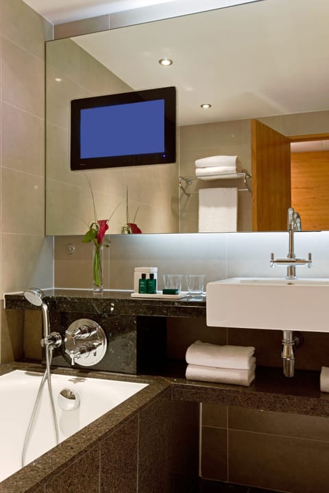 Separate tub and shower, designer toiletries, hair dryer, bathrobes