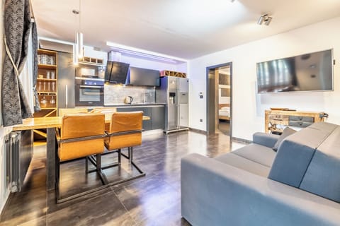 Deluxe Condo | Living area | 32-inch flat-screen TV with satellite channels, TV